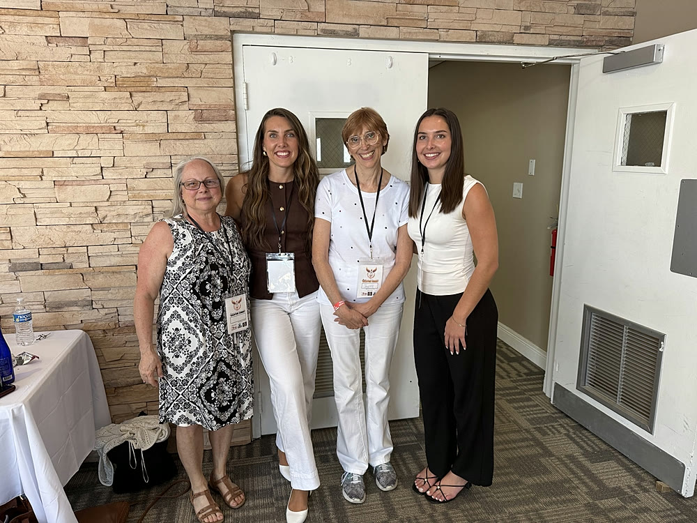 Kaelin Coe with clients and fellow attendees at a conference