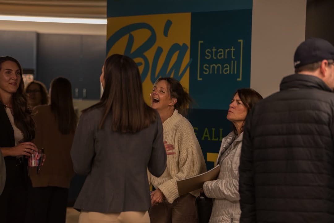 Kaelin Coe sharing a laugh with attendees at a conference