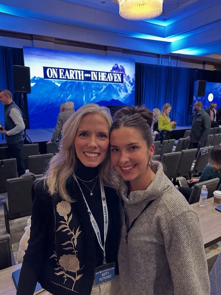 Kinley Coe with a fellow attendee at a wealth-building conference