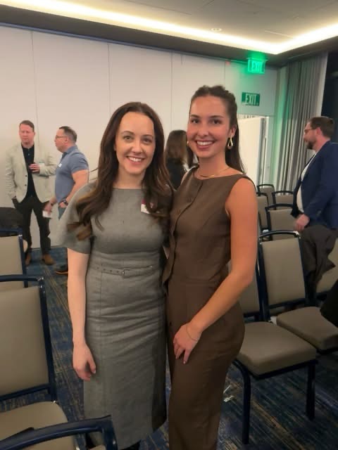 Two Digital Asset Sisters team members at an industry event