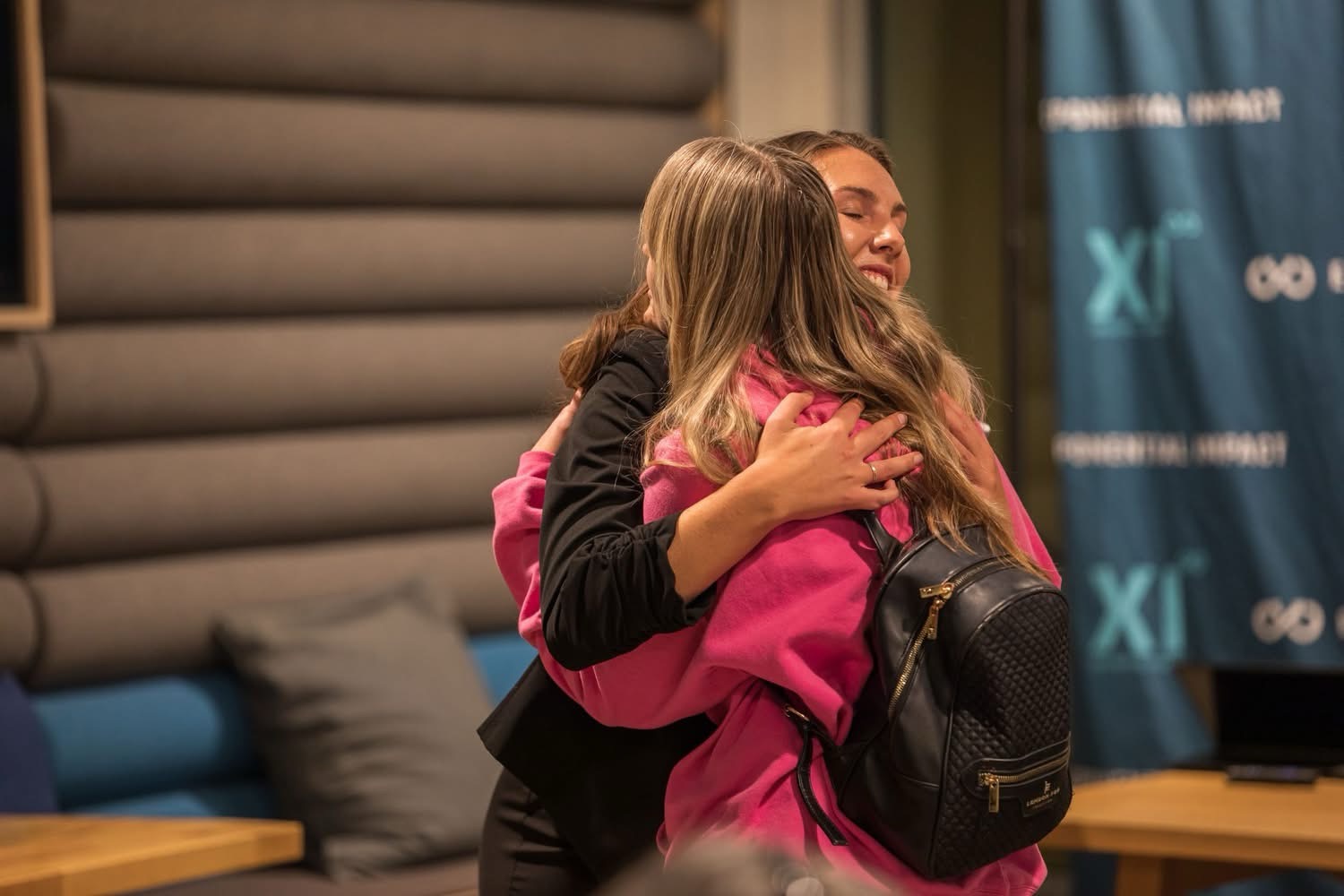 Kinley Coe greeting a fellow attendee at a conference