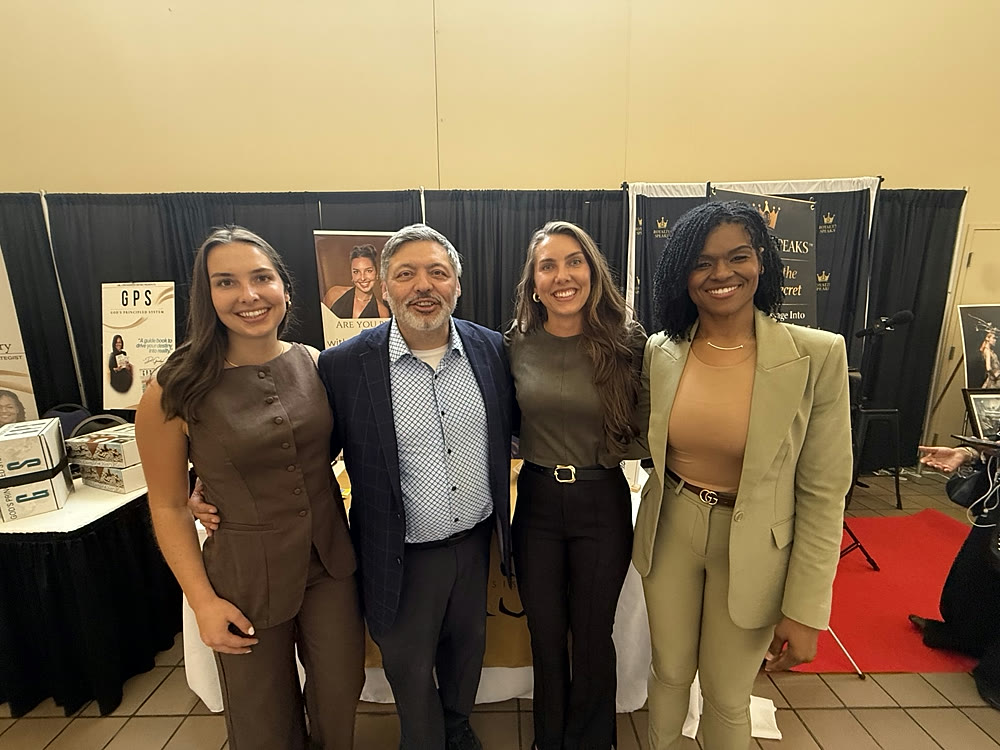 Kaelin and Kinley Coe with fellow vendors at a conference booth